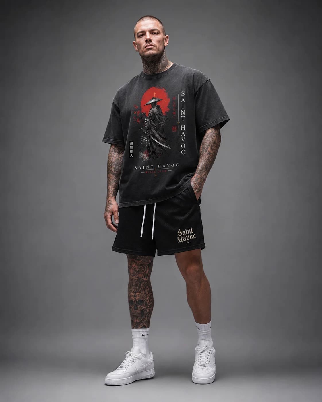 Model wearing a washed-black Saint Havoc graphic tee in an oversized fit
